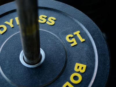Close up of a man lifting weights in gym