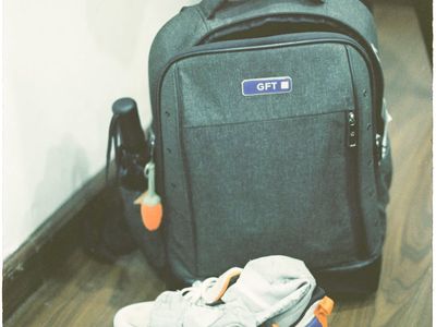 Professional sports sneakers and gear on wooden floor